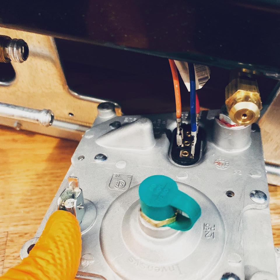 Technician fixing a Kitchen Aid range stove in Chicago & Suburbs