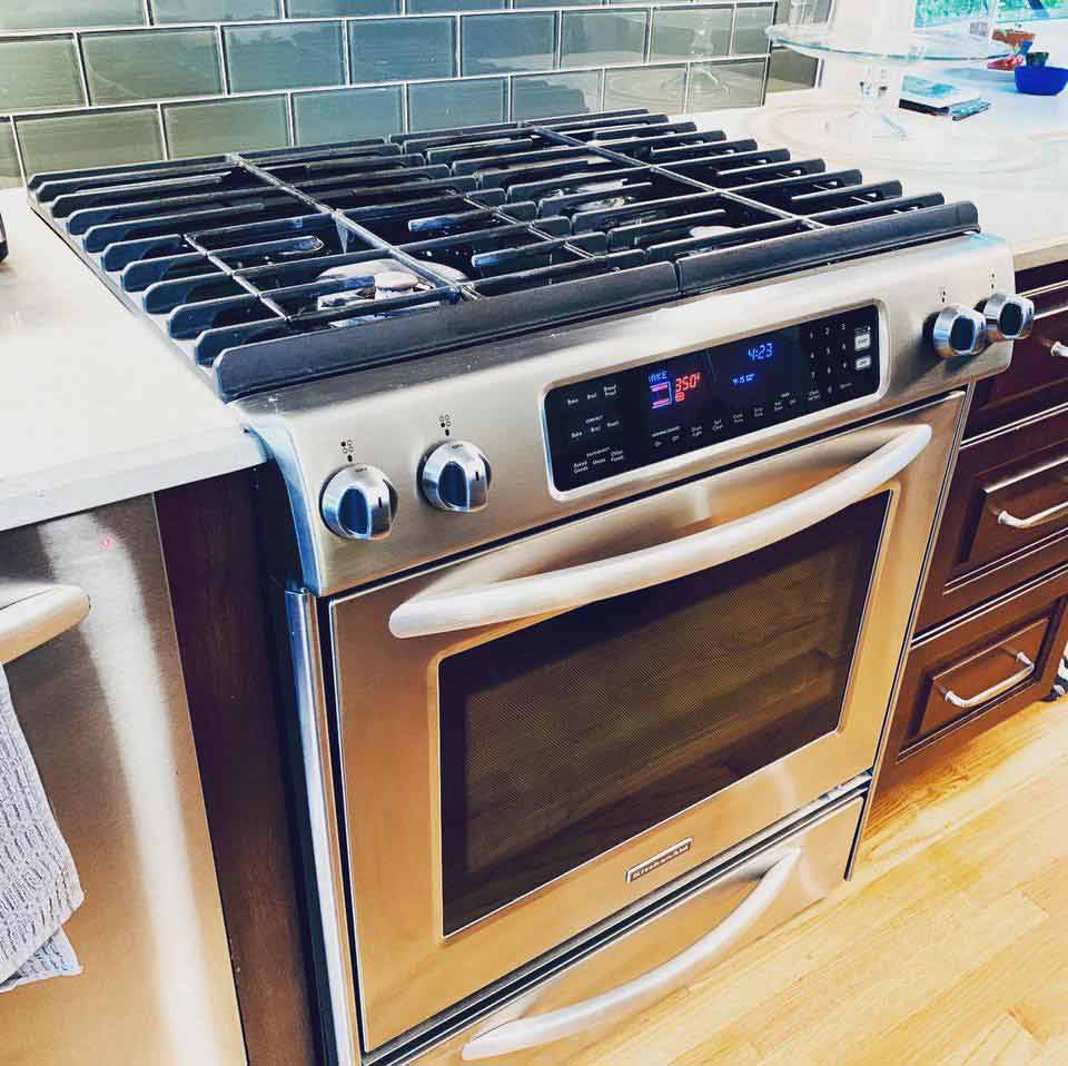Professional repairing a Kitchen Aid range stove in Chicago & Suburbs