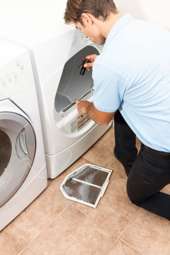 Technician repairing a washer, showcasing Maytag dryer repair services in Chicago